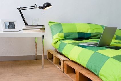 Pallet bed diy in modern bedroom with laptop